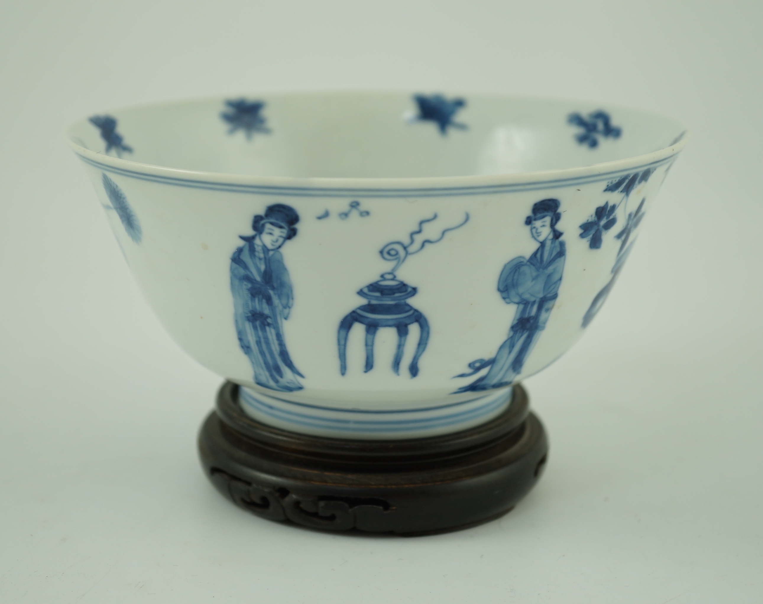 A Chinese blue and white ‘ladies’ bowl, Kangxi period, 15.5cm diameter, wood stand